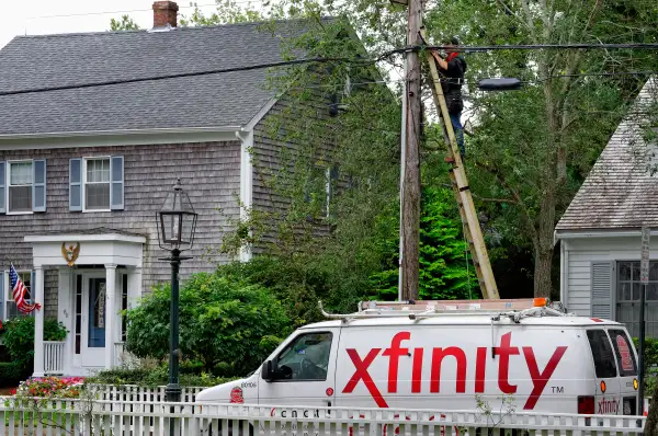Comcast worker intalls xfinity cable service to residential