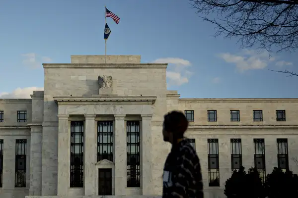 A pedestrian walks past the Marriner S. Eccles Federal Reserve building in Washington, D.C., on December 15, 2015.