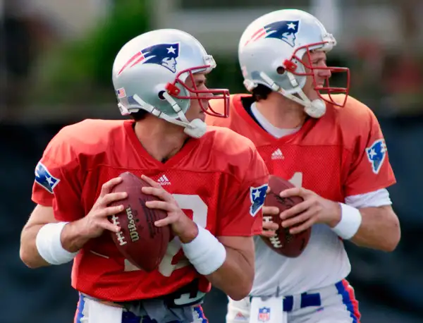 New England Patriots quarterbacks Tom Brady (L) and Drew Bledsoe drop back together during passing drills at a team practice at Tulane University in New Orleans Louisiana, January 30, 2002. Patriots Head Coach Bill Belichick was expected to announce which quarterback will start Superbowl XXXVI against the St. Louis Rams after the practice.