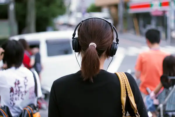 woman wearing headphones on street