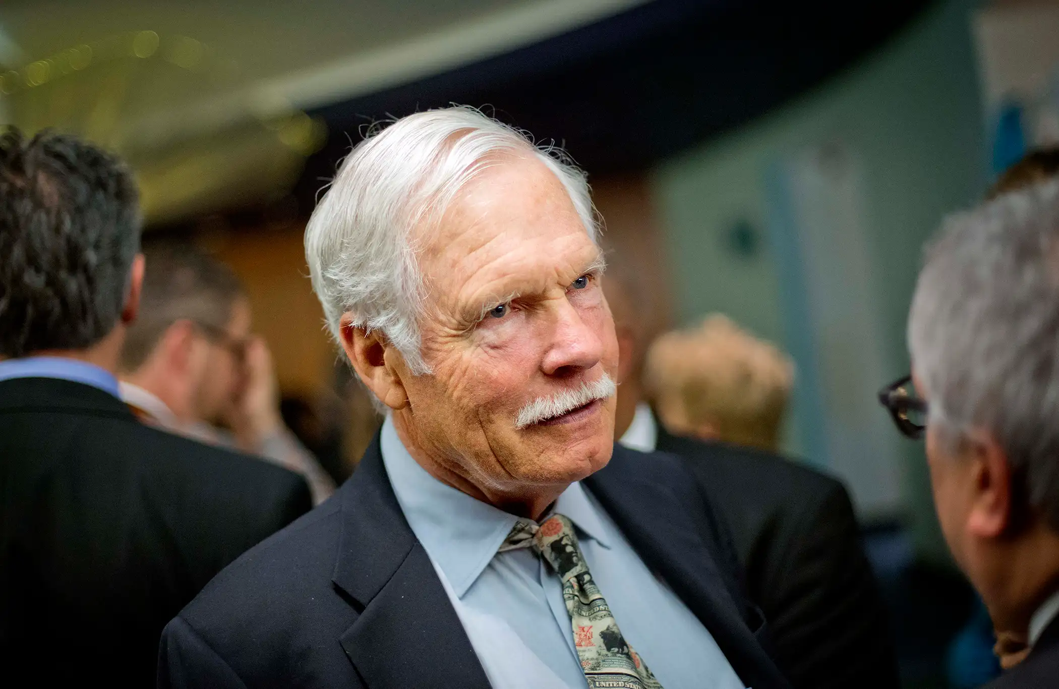 In this Friday, Dec. 6, 2013 photo, Ted Turner talks with guests at the Captain Planet Foundation benefit gala in Atlanta.