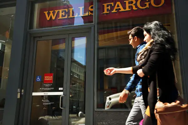 Pedestrians pass a Wells Fargo bank branch in lower Manhattan on April 15, 2016 in New York City.