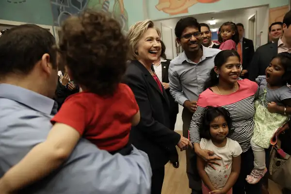 Democratic presidential candidate and former U.S. Secretary of State Hillary Clinton greets students and parents at a KinderCare daycare center May 9, 2016 in Fairfax, Virginia. Clinton's campaign stops in Virginia today were a continuation of her  Breaking Down Barriers  tour highlighting her policies on affordable child care, paid family leave and health care.
