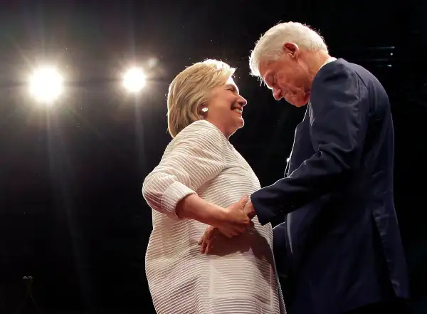 Democratic presidential candidate Hillary Clinton, second from right, greets her husband, former president Bill Clinton during a presidential primary election night rally, June 7, 2016, in New York.