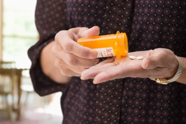 Mixed race woman holding medication pills