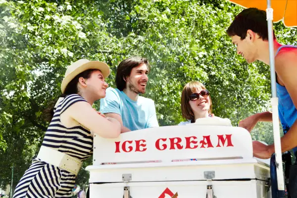 Friends buying ice cream from the vendor