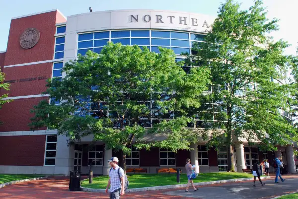 Students walk by Shillman's Hall on the Northeastern Univers