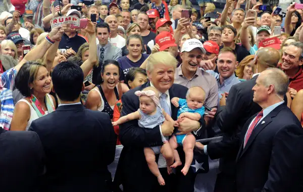 US Republican Presidential Candidate Donald Trump holds two babies after his Town Hall address at the Gallogly Events Center in Colorado Springs, Colorado, on July 29, 2016.