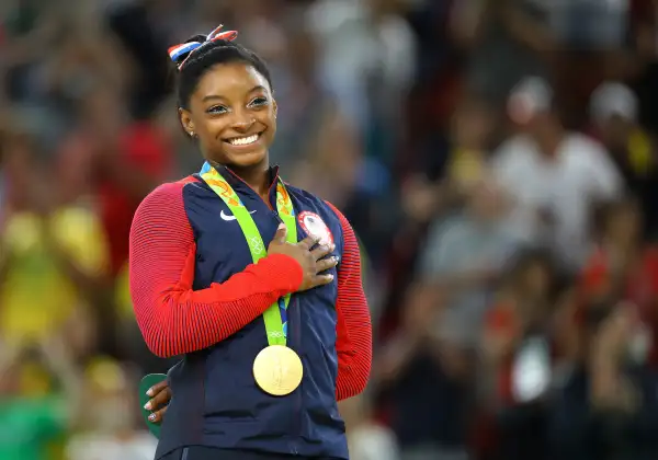 Gold medalist Simone Biles (USA) of USA places her hand on her heart as her national anthem is played after the Women’s Floor Final in the 2016 Rio Olympics, Rio Olympic Arena, Rio de Janeiro, Brazil, August 16, 2016.