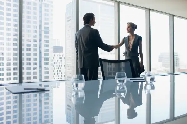 Business people shaking hands in conference room