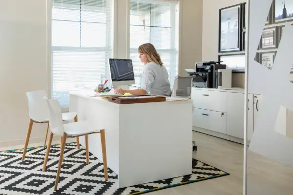 Woman working at computer in home office