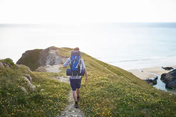 Hiker walking along coastal path