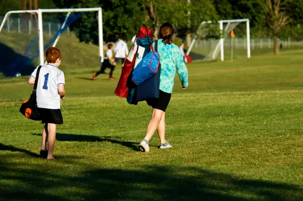 Soccer Mom with Son walking to Soccer Game