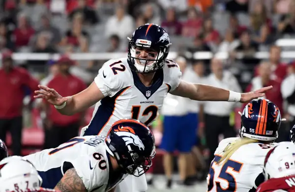 Denver Broncos quarterback Paxton Lynch (12) waves his arms a the line of scrimmage during the first quarter against the Arizona Cardinals September 1, 2016 at University of Phoenix Stadium in Glendale.
