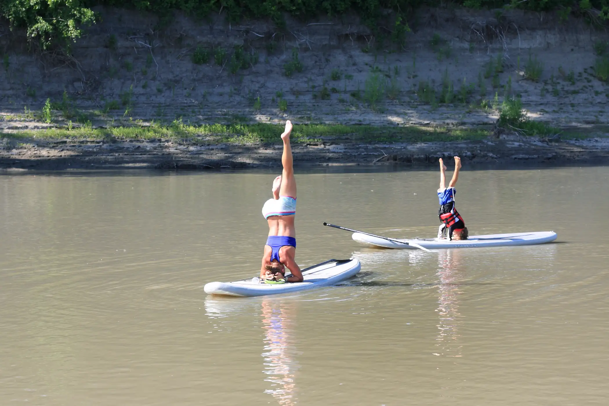 Grand Forks, North Dakota. Grand Forks is home to University of North Dakota, the Grand Forks Air Force Base, and a slice of the Red River, which is itself occasionally host to some very talented yoga practitioners.