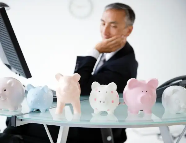 piggy banks lined up on office desk