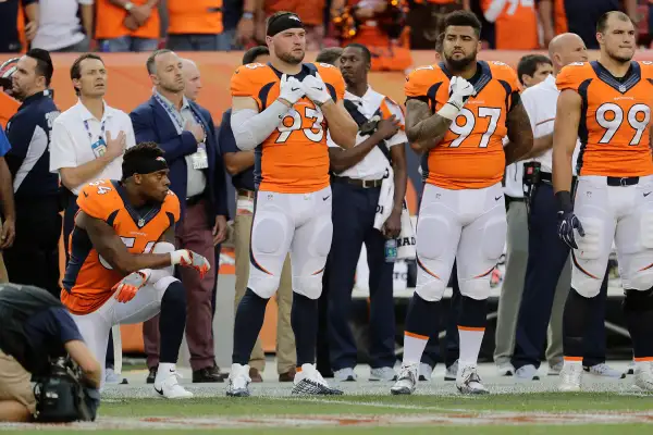 Denver Broncos inside linebacker Brandon Marshall (54) kneels during the National Anthem.