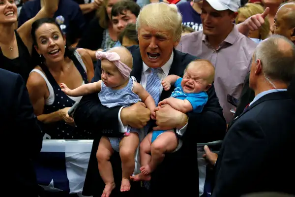 Republican presidential nominee Donald Trump holds babies at a campaign rally in Colorado Springs, Colorado, July 29, 2016.