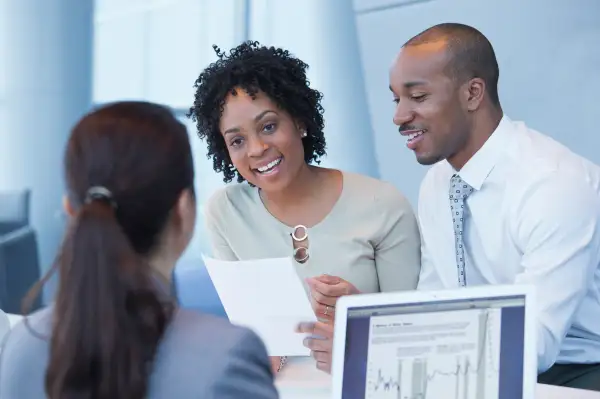 Couple talking to loan officer