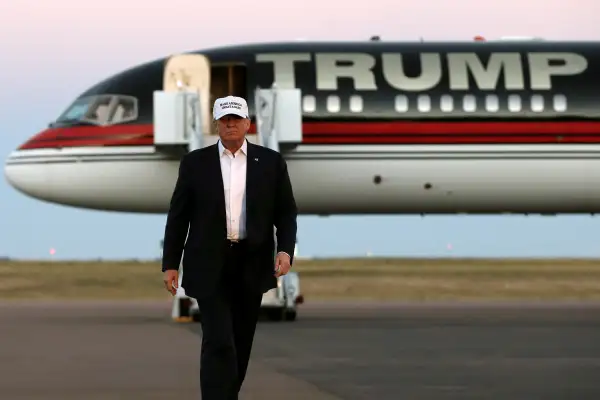 Republican presidential nominee Donald Trump walks off his plane at a campaign rally in Colorado Springs, Colorado, September 17, 2016.