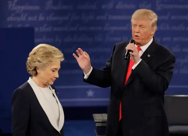 Democratic presidential nominee Hillary Clinton walks past Republican presidential nominee Donald Trump during the second presidential debate at Washington University in St. Louis, Sunday, Oct. 9, 2016.