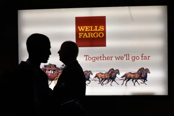 Men pass a sign at Wells Fargo Center at the Democratic National Convention in Philadelphia, Pennsylvania, U.S. July 25, 2016.