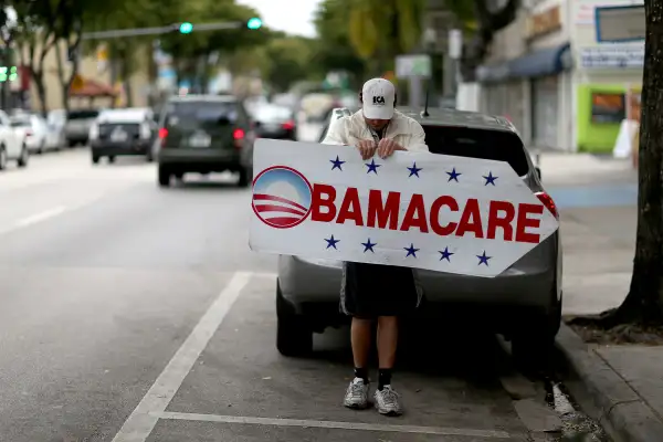 Pedro Rojas holds a sign directing people to an insurance company where they can sign up for the Affordable Care Act, also known as Obamacare, before the February 15th deadline on February 5, 2015 in Miami, Florida.