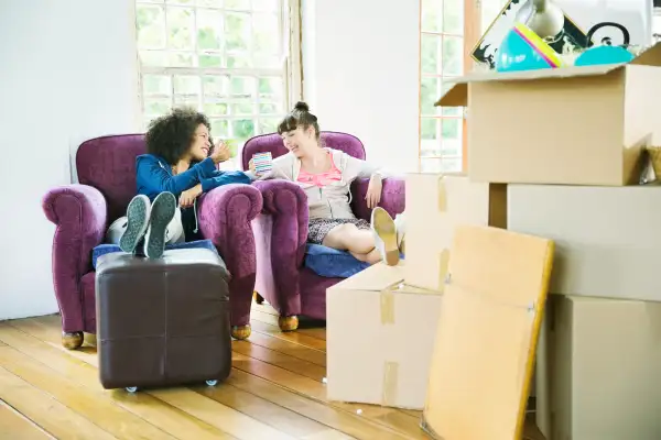 Women having coffee together in new home