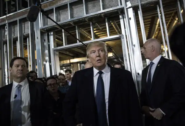 Donald Trump, president and chief executive of Trump Organization Inc. and 2016 Republican presidential candidate, center, attends a media tour of the Trump International Hotel Washington DC in Washington, D.C., U.S., on Monday, March 21, 2016.