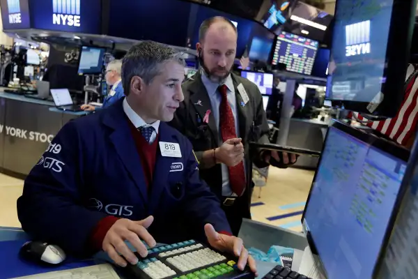 Trader Anthony RInaldi, left, works on the floor of the New York Stock Exchange, November 7, 2016.