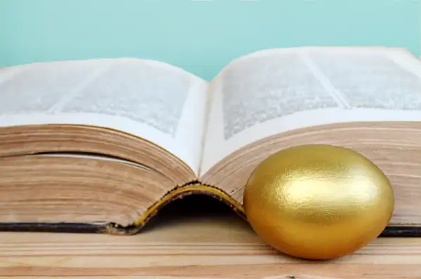 gold egg and book