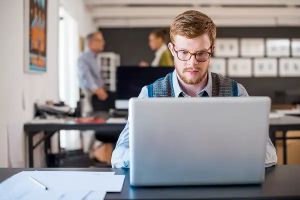 Young businessman using laptop