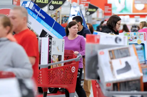A woman maneuvers her way through Black Friday shoppers at the Target store