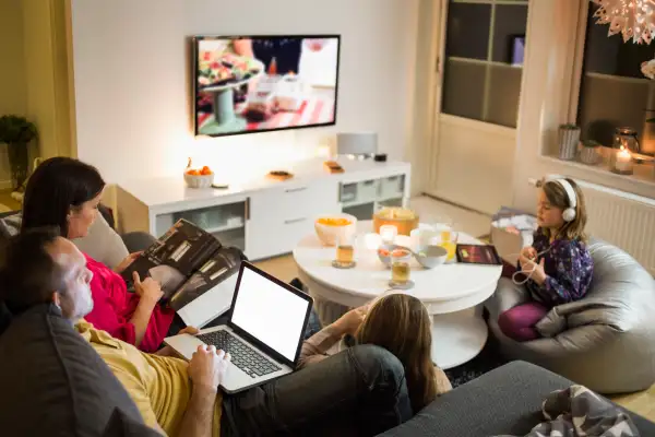 Family using technologies in living room