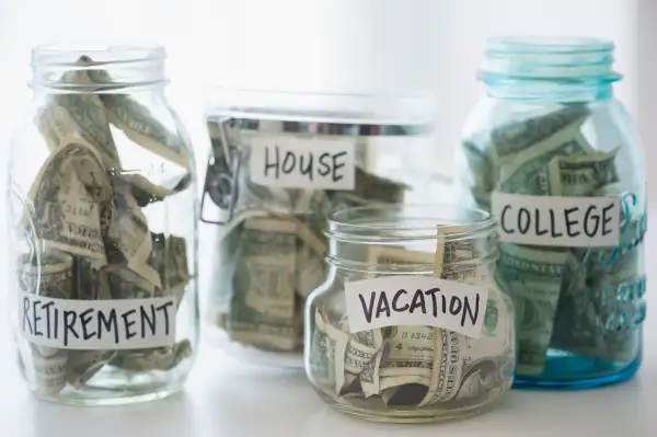 Close up of savings jars with money