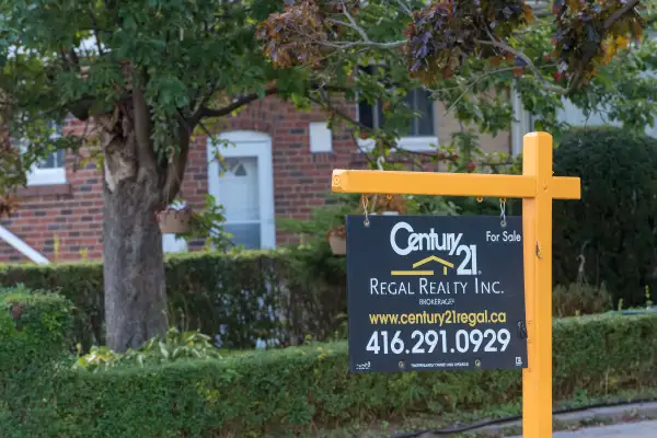 Housing Market: Century 21 realtor board with a for-sale