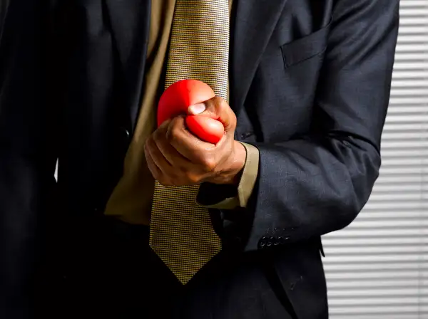 Squeezing stress ball.