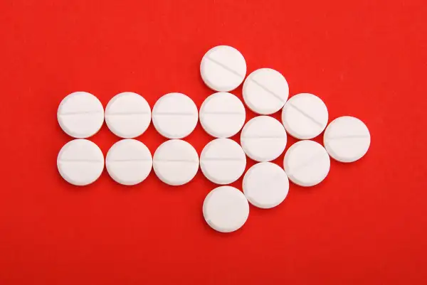 Arrow of Pills on red background