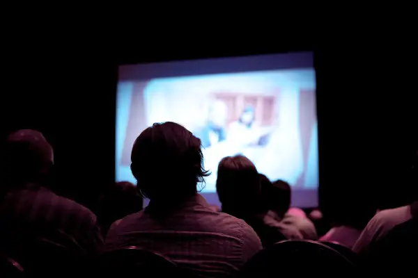 people sitting in a dark movie theater