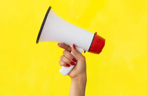 Womans hand holding megaphone