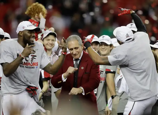 tlanta Falcons owner Arthur Blank dances with players after the NFL football NFC championship game