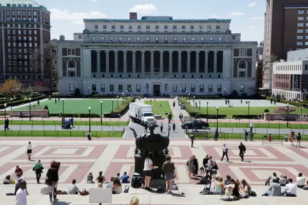 Students sunbathe on the steps of Columbia University's Low Memorial Library, foreground, April 29, 2015 in New York. Butler Library is top center. (AP Photo/Mark Lennihan)