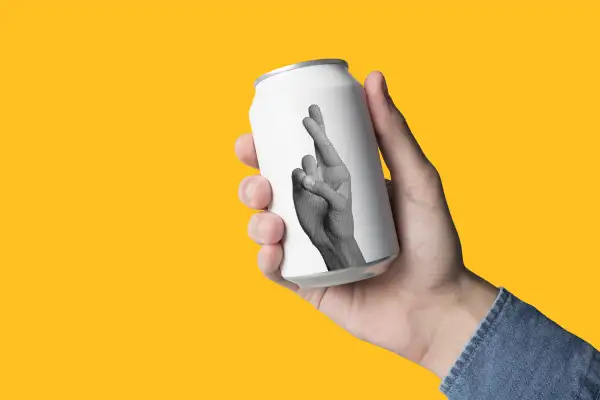 photo illustration of beer can with crossed fingers printed on it