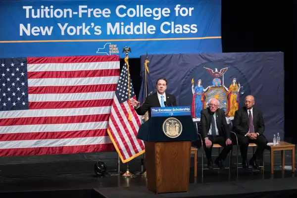 New York Gov. Andrew Cuomo, left, is joined by Vermont Sen. Bernie Sanders, center, and Chairperson of the Board of Trustees of The City University of New York William C. Thompson, as he speaks during an event at LaGuardia Community College, Tuesday, Jan. 3, 2017, in New York. Gov. Cuomo announced a proposal for free tuition at state colleges to hundreds of thousands of low- and middle income residents. Under the governor's plan, which requires legislative approval, any college student accepted to a New York public university or two-year community college is eligible, provided their family earns less than $125,000.