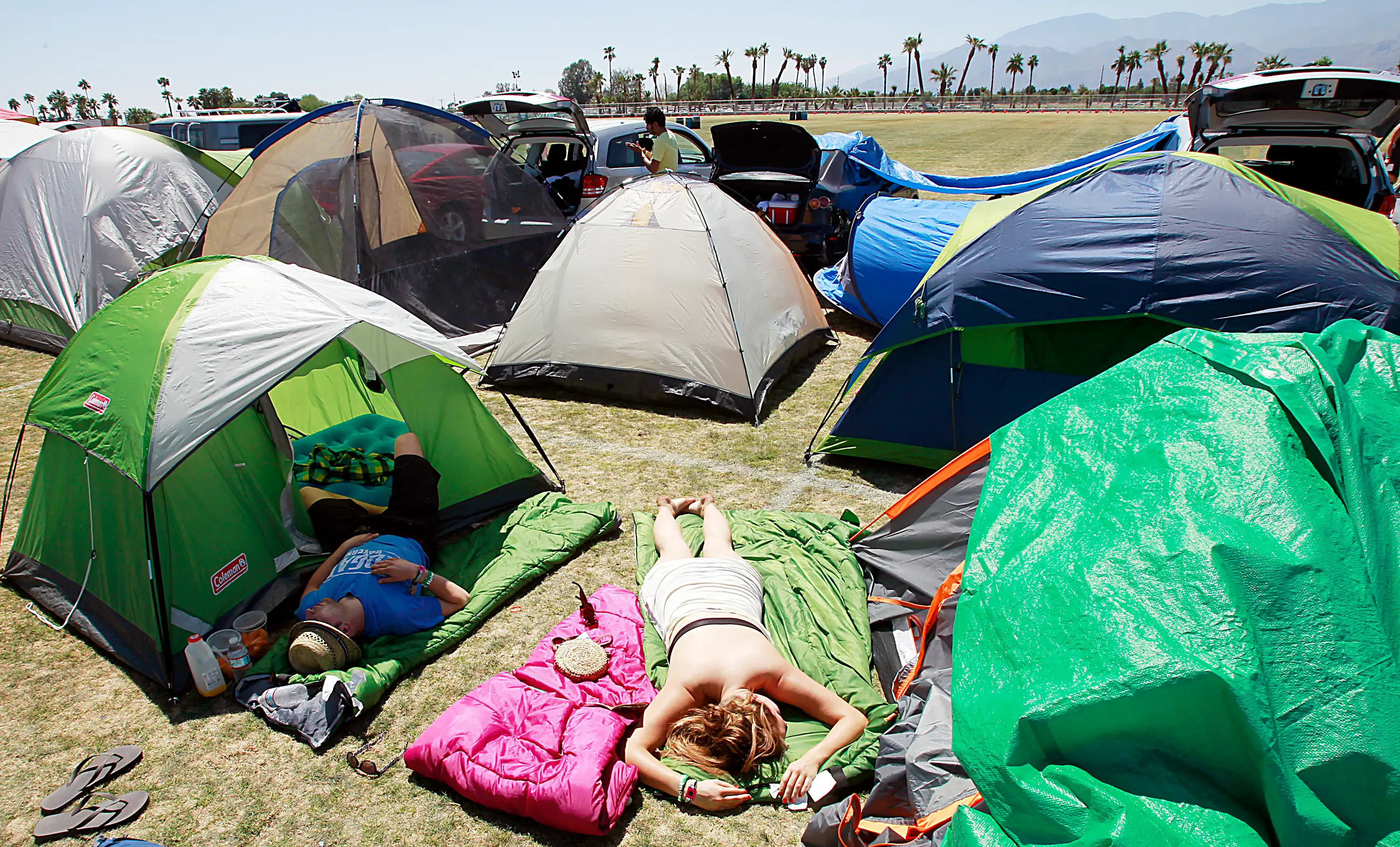 Festivalgoers get some sun and sleep at an onsite campground Sunday, April 17, 2011, at the Coachel