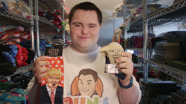 John Cronin holds up pairs of Donald Trump socks.