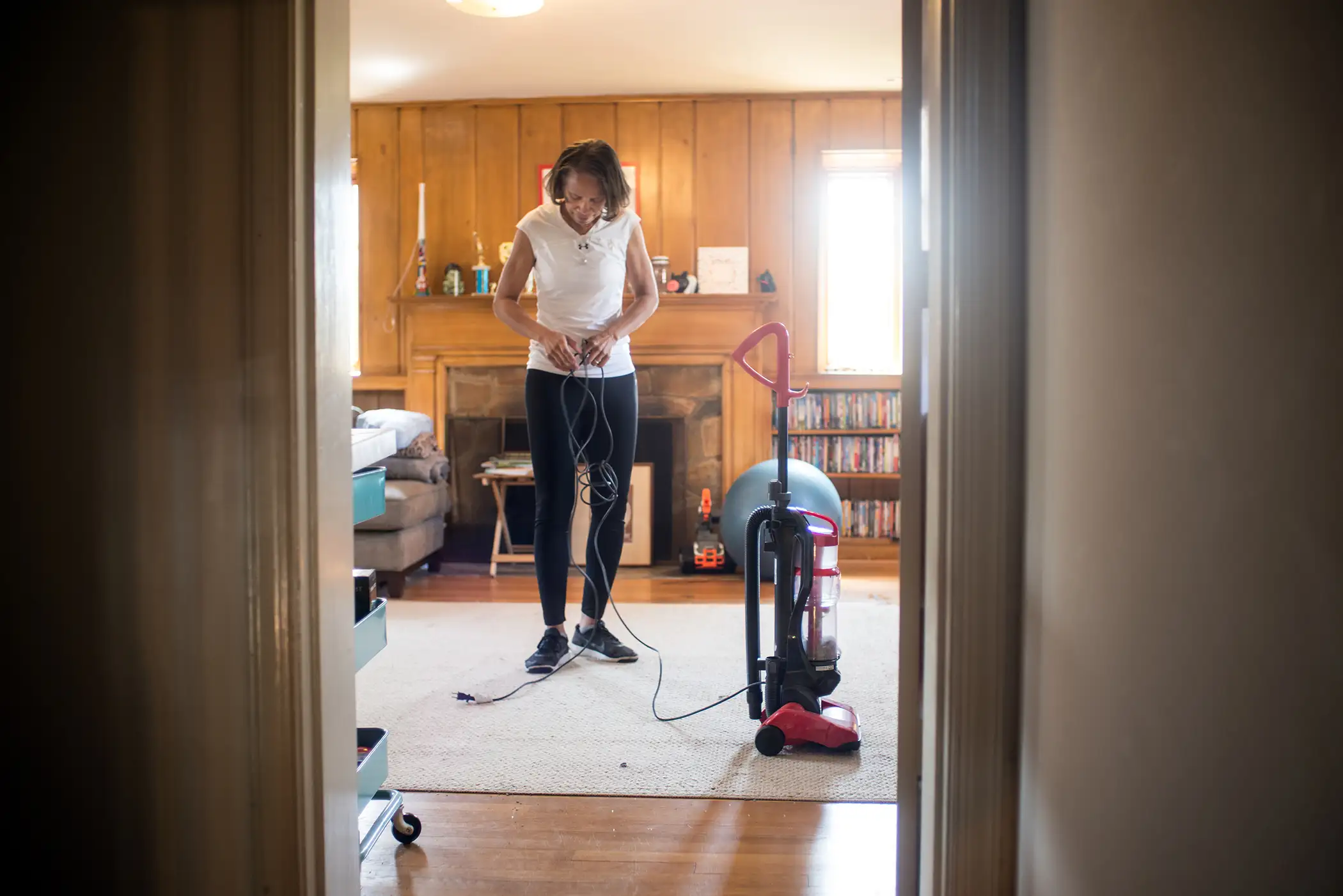 Unemployed lawyer Karen Johnson vacuums her family room while her family is at work and school, April 14, 2017.