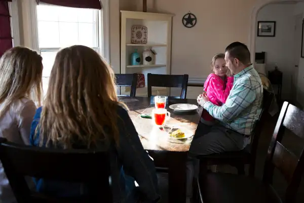 Nathan Bonds spends time at home with his daughters Courtney (15), Sierra (16), and Ava (7) before leaving for work, April 11, 2017.