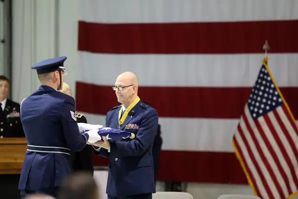 Brig. Gen. Brent Feick, outgoing director of joint staff for the Alaska National Guard, participates in a flag folding ceremony during his retirement ceremony at the National Guard armory on Joint Base Elmendorf-Richardson, Alaska, April 1, 2017. Feick retired after 41 years of service to our nation.