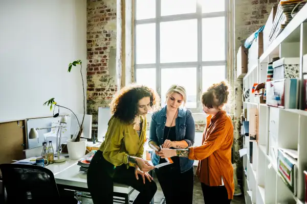 Businesswomen having an informal meeting in a large office space